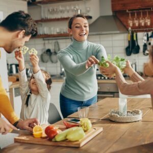 Happy family having fun while preparing healthy food in the kitchen.