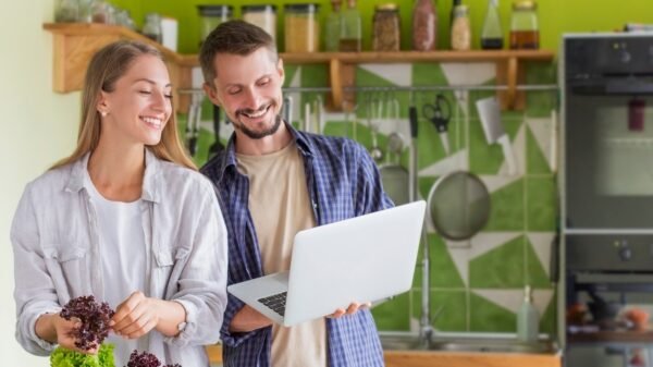 Couple cooking healthy food at house kitchen, preparing lunch